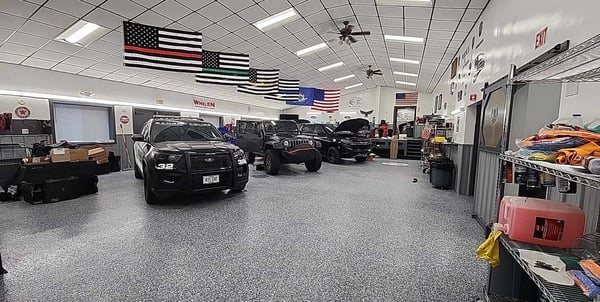 Shop interior with row of custom vehicles