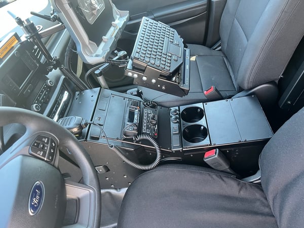 center console of police vehicle with laptop