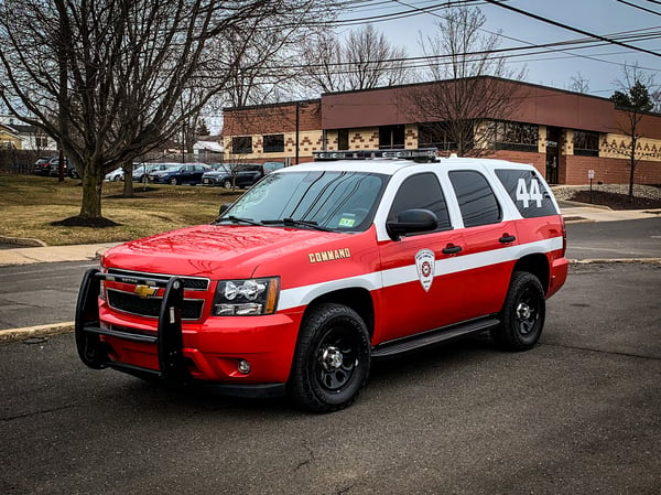 red and white fire department SUV
