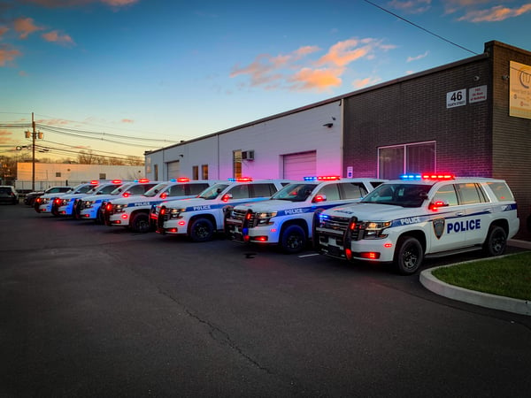 Row of police vehicles with exterior lighting