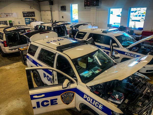 line of police vehicles being upfitted