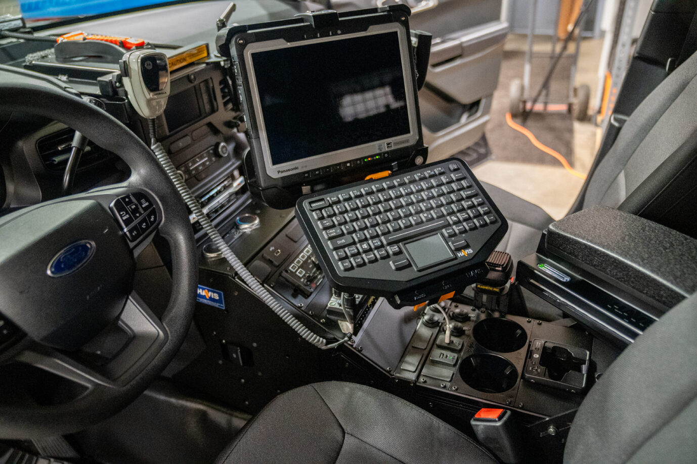 rugged laptop in console of police vehicle