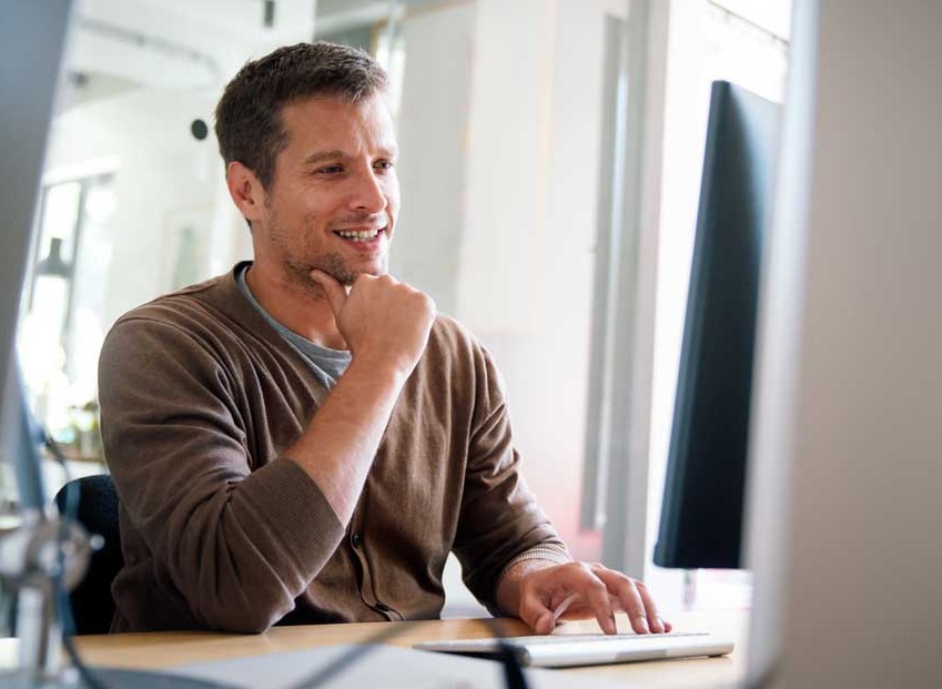 Smiling IT professional at computer